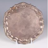 A George II silver circular card salver, the centre crest engraved within a scallop shell and reeded