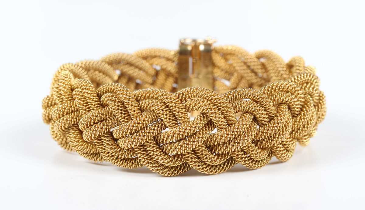 A gold bracelet in an interwoven ropetwist form design, on a sliding clasp, detailed ‘18A B’, weight