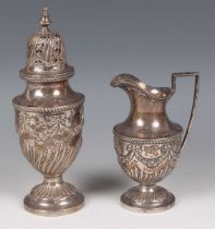 A late Victorian silver baluster sugar caster and matching milk jug, each embossed with floral