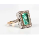 A gold, emerald and diamond rectangular cluster ring, collet set with the cut cornered rectangular