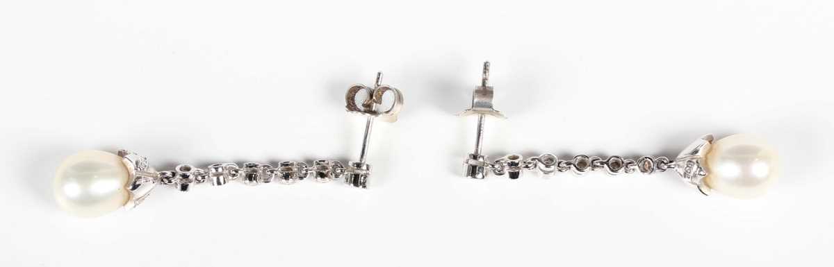 A pair of white gold, diamond and cultured pearl pendant earrings, each mounted with a drop shaped - Image 2 of 2