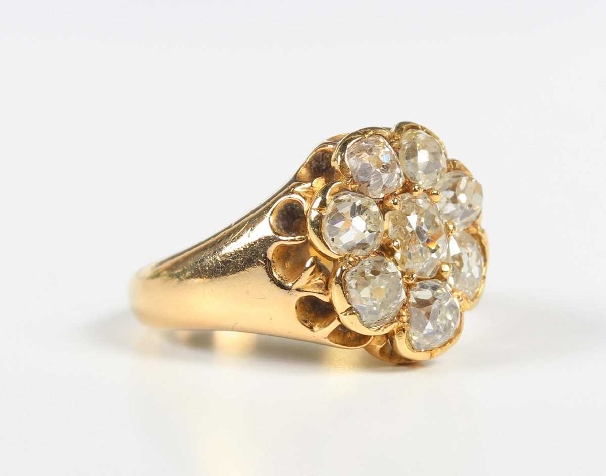 A gold and diamond cluster ring, claw set with a central old mine cut diamond within a surround of