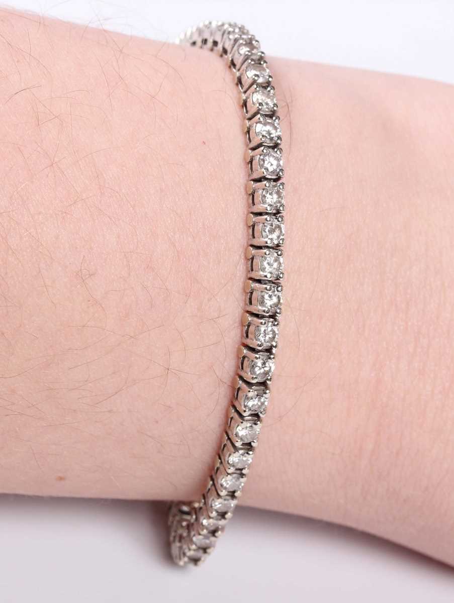 A diamond line bracelet, claw set with a row of circular cut diamonds, on a snap clasp with a - Image 3 of 3
