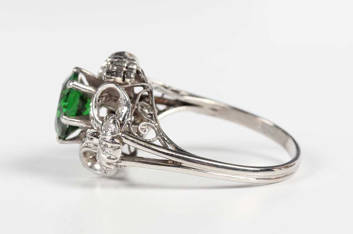 A platinum, demantoid garnet and diamond ring, claw set with the circular cut green demantoid garnet - Image 3 of 5