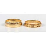 An 18ct gold wedding band ring, London 1970, ring size approx M1/2, and an 18ct gold decorated