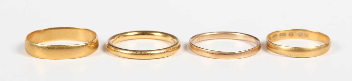 A 22ct gold wedding ring, Birmingham 1921, ring size approx L, and three further 22ct gold wedding