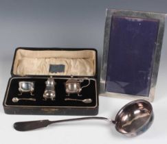 A George V silver three-piece condiment set, comprising mustard, pepper caster and salt with two