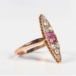 A gold, ruby and diamond marquise shaped cluster ring, mounted with four cushion cut rubies to the