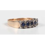 A gold, sapphire and diamond ring, mounted with a row of five circular cut sapphires between four