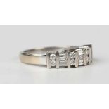 An 18ct white gold and diamond ring, mounted with three rows of three tapered baguette cut