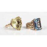 A gold ring, claw set with a cut cornered rectangular step cut synthetic blue spinel between pierced