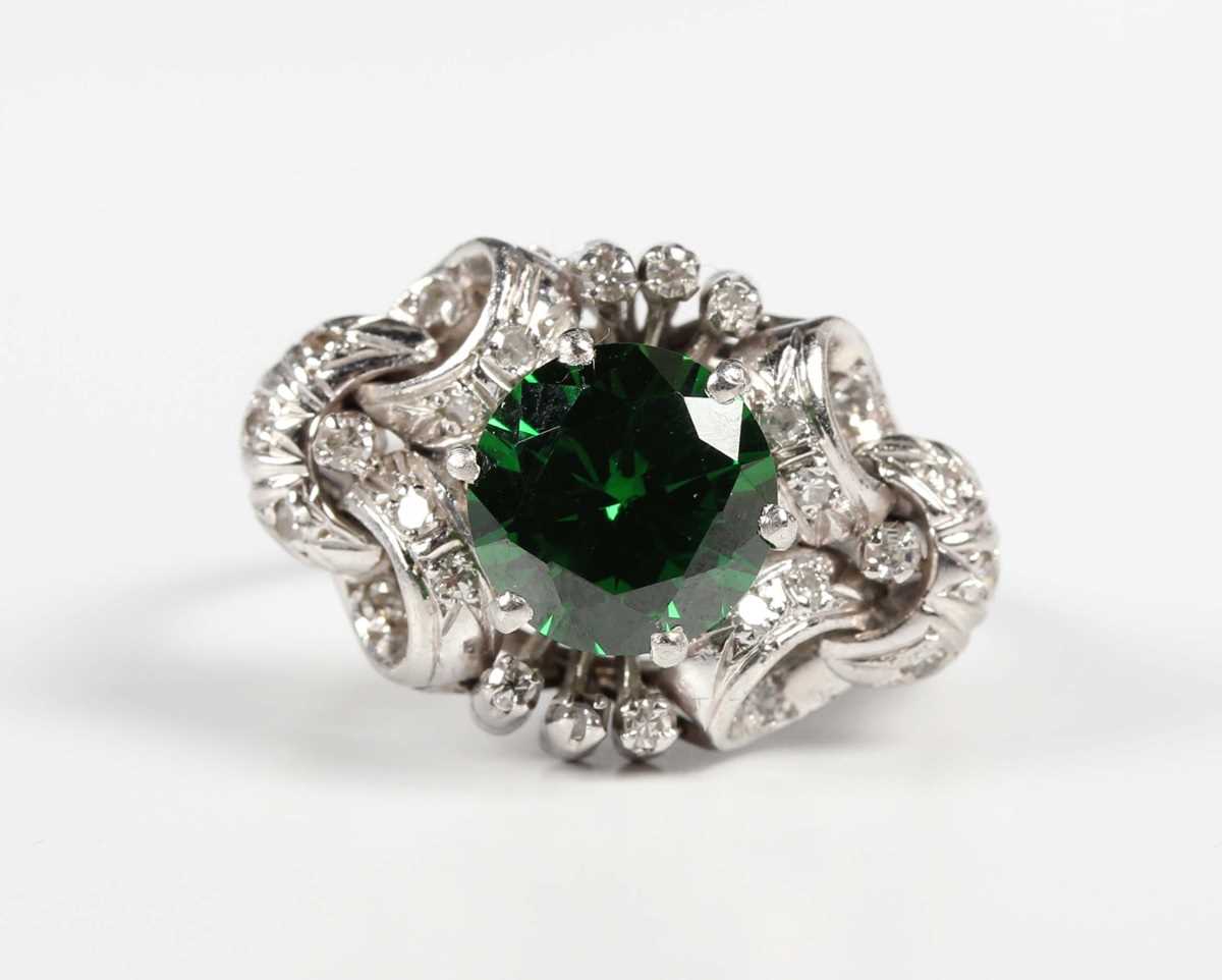 A platinum, demantoid garnet and diamond ring, claw set with the circular cut green demantoid garnet - Image 2 of 5