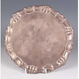 A George II silver circular card salver, the centre crest engraved within a scallop shell and scroll