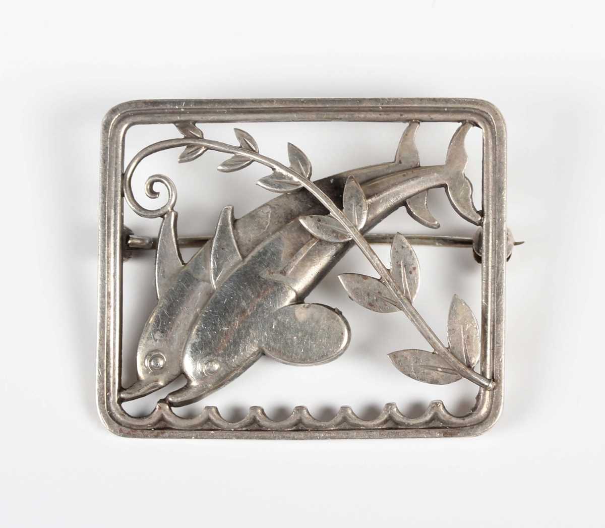 A Georg Jensen sterling silver rectangular brooch, designed as two dolphins with a foliate spray,