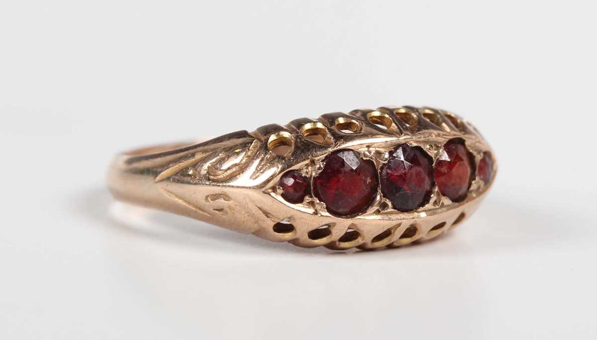 A 9ct gold and garnet five stone ring in a boat shaped design, Chester 1920, weight 1.7g, ring