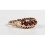 A 9ct gold and garnet five stone ring in a boat shaped design, Chester 1920, weight 1.7g, ring