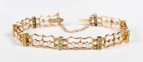 An Edwardian gold, demantoid garnet and half-pearl bracelet, designed as pierced panel form links