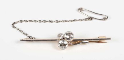 A gold, platinum fronted and diamond three stone bar brooch, collet set with circular cut