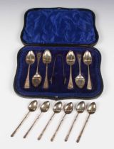 A set of six silver coffee spoons and a pair of matching sugar tongs with engraved decoration,