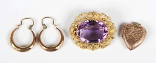 An early Victorian gold and amethyst brooch, mounted with an oval cut amethyst within a cannetille