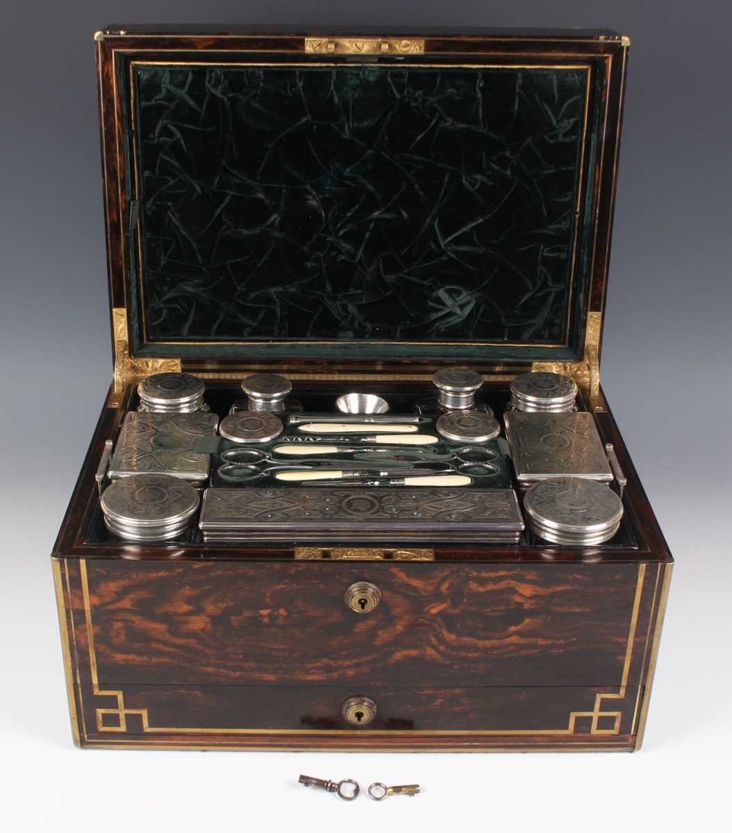 A Victorian coromandel cased travelling vanity box, the compartmentalized interior fitted with