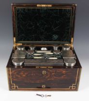 A Victorian coromandel cased travelling vanity box, the compartmentalized interior fitted with