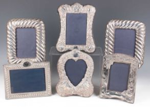 A pair of Elizabeth II silver mounted rectangular photograph frames with spiral reeded decoration,