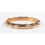 A 9ct gold oval hinged bangle of bamboo design, Birmingham 1962, weight 13.6g, inside width 6cm,