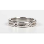 A platinum and diamond eternity ring of twin band form, mounted with pairs of circular cut