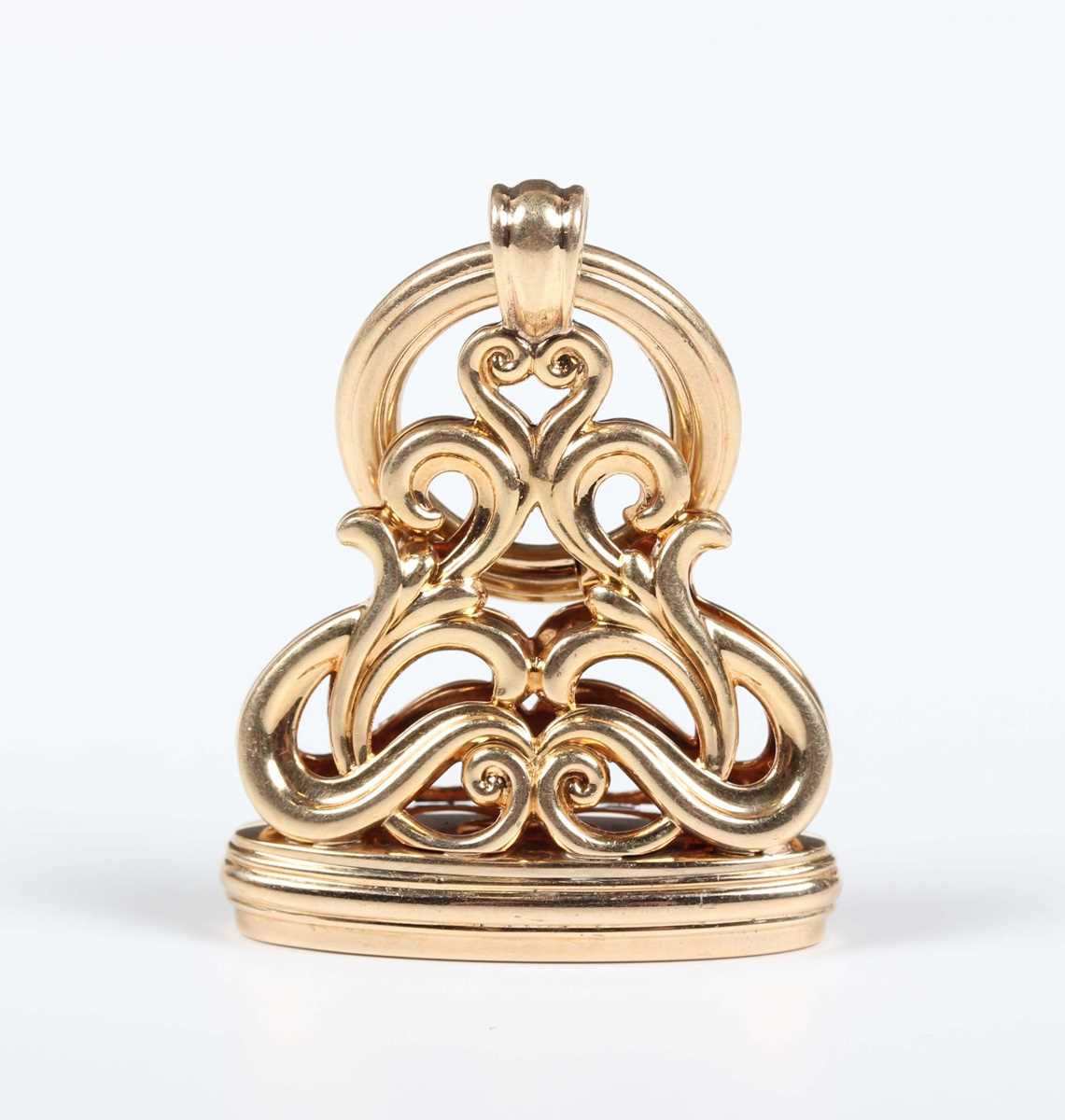 A gold pendant seal, the mount in a scroll pierced design, fitted with a suspension ring,