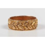 A late Victorian 9ct gold wedding band ring with foliate decoration, Birmingham 1894, weight 4.2g,