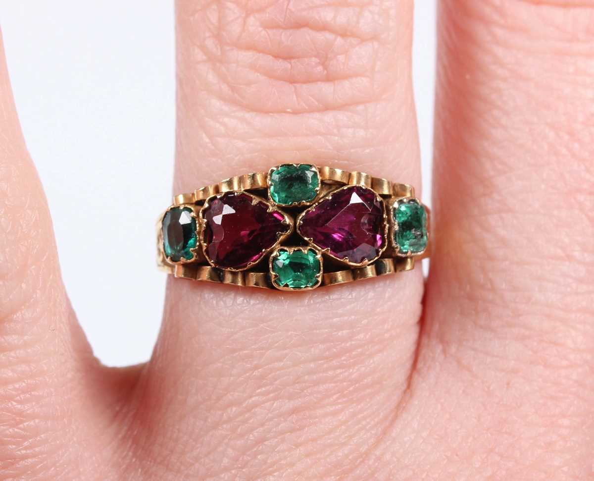 A 12ct gold, garnet, emerald and green gem set ring, mounted with two heart shaped garnets to the - Image 9 of 9