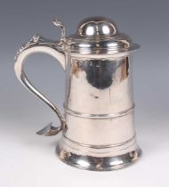 A George III silver tankard of tapering cylindrical girdled form, the domed hinged lid and pierced
