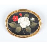 A gold and pietre dure oval brooch in a floral design, 19th century, the mount decorated with an