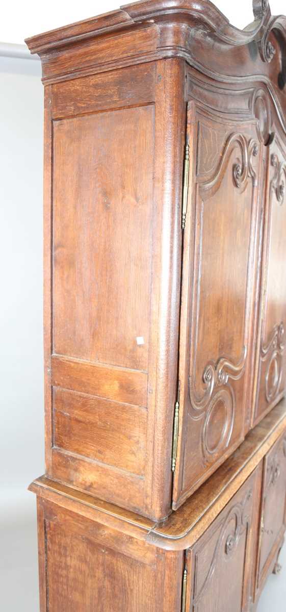 A 19th century French oak side cabinet with an arched pediment and four carved panel doors, height - Image 9 of 14