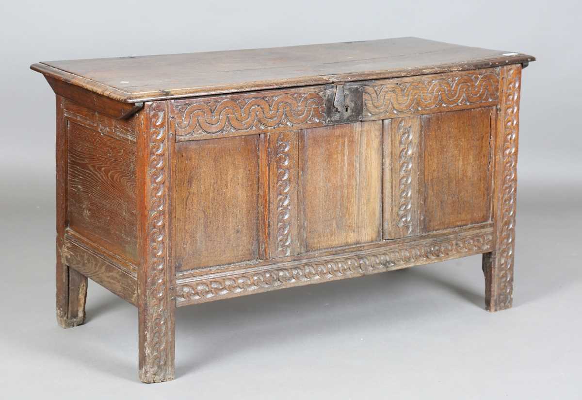 A 17th century oak panelled coffer, the lid with original wire hinges, height 71cm, width 125cm,