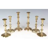 A pair of early 18th century brass candlesticks with knop stems and shaped bases, height 20cm,