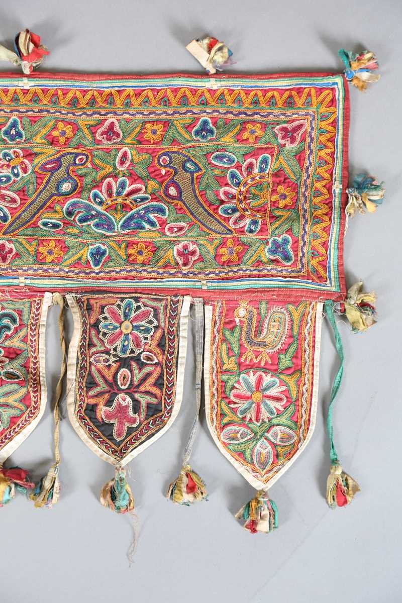 An Indian kutch embroidered door hanging, finely worked in coloured threads, width 98cm. Provenance: - Image 2 of 6
