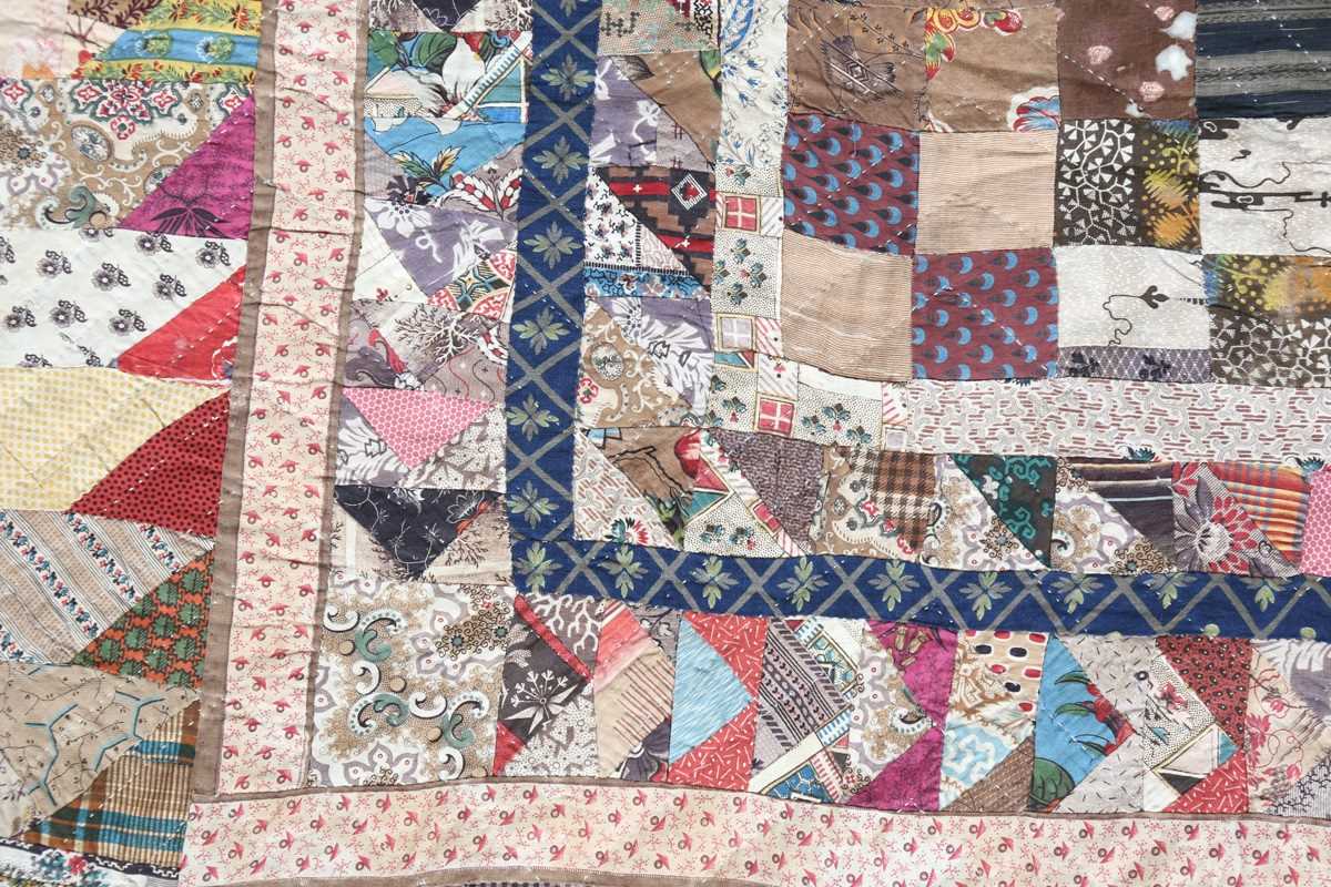 A large mid-19th century cotton 'medallion' patchwork quilt, finely worked with overall printed - Image 4 of 10