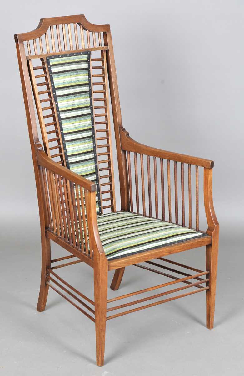 An Edwardian Arts and Crafts mahogany armchair with spindle back and sides, height 115cm, width