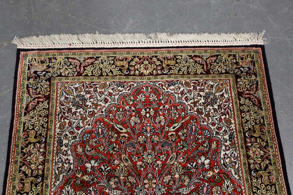 A Qum part silk prayer rug, Central Persia, late 20th century, the red mihrab with an ascending vase - Image 2 of 6