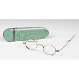 A late 18th century shagreen and white metal mounted spectacles case, length 13cm, containing a pair
