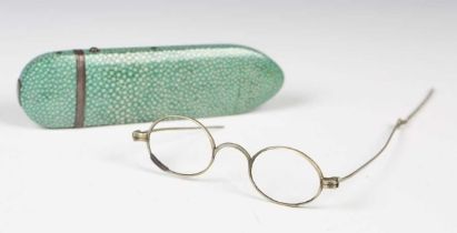 A late 18th century shagreen and white metal mounted spectacles case, length 13cm, containing a pair