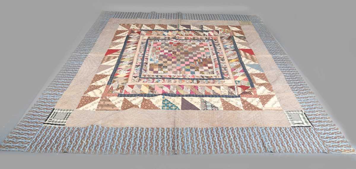 A large mid-19th century cotton 'medallion' patchwork quilt, finely worked with overall printed