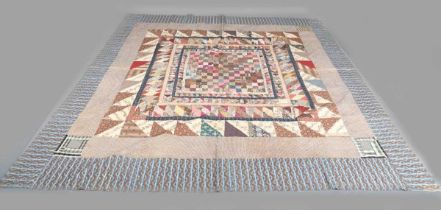 A large mid-19th century cotton 'medallion' patchwork quilt, finely worked with overall printed