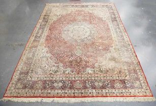 A fine Kashmir part silk carpet, late 20th century, the red field with a large flowerhead medallion,
