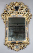 A late 19th century Rococo Revival giltwood sectional wall mirror with scrolling frame and