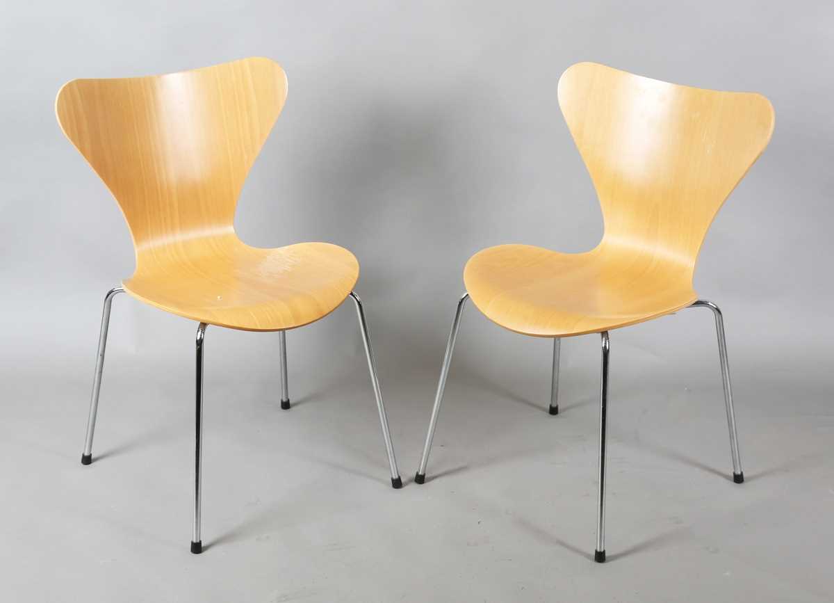 A pair of modern Fritz Hansen plywood and chromium plated metal chairs, originally designed by