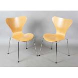 A pair of modern Fritz Hansen plywood and chromium plated metal chairs, originally designed by