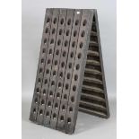 A French oak riddling rack, pierced to hold 120 champagne bottles, height 147cm, width 72cm.